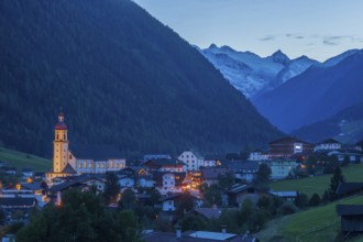 View of town with mountains and Stubai glacier at dusk, Neustift im Stubai Valley, Stubai Valley,