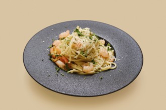 Delicious creamy garlic shrimp pasta is plated beautifully with fresh herbs and a sprinkle of