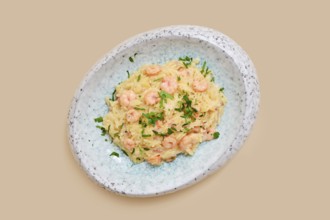 A delightful dish features risoni pasta mixed with tender shrimp and sprinkled with fresh herbs.