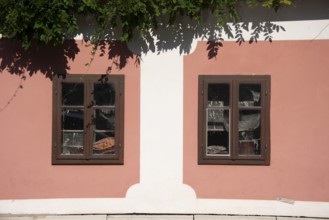 Pink house facade, window with old objects, Kranj, Upper Carniola, Slovenia