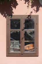 Pink house facade, window with old objects, Kranj, Upper Carniola, Slovenia