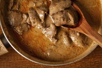 Beef stroganoff, pan cooking, close-up, homemade