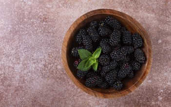 Blackberries, in a wooden bowl, top view, no people