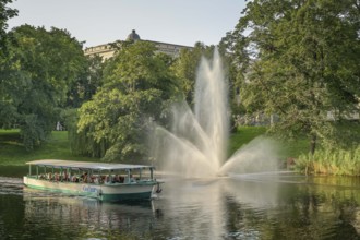 People, leisure, sightseeing boat, fountain, city canal, municipal park, Riga, Latvia