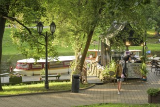 People, leisure, sightseeing boat, city canal, municipal park, Riga, Latvia