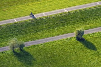 Aerial view, cycle path and cyclist in the foothills of the Rhine Perrich, green meadows and green