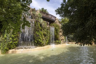 Beautiful natural park, with a bridge over waterfalls The Ornamental Pond in Genovés Botanic