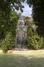 Beautiful natural park with a wide multi-tiered waterfall, The Ornamental Pond in Genovés Botanic