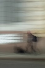 Abstract of a man walking in front of a building captured using ICM intentional camera movement