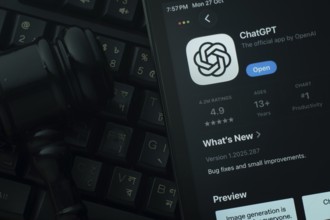 Dhaka, Bangladesh- 28 Oct 2025: An iPad displaying the ChatGPT app against a judge's gavel and dark