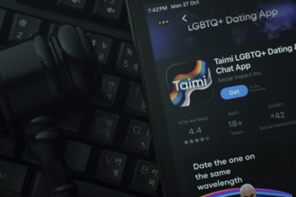 Dhaka, Bangladesh- 28 Oct 2025: An iPad displaying the Taimi app against a judge's gavel and dark