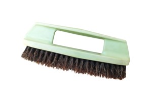 Old green plastic shoe brush on a isolate white background