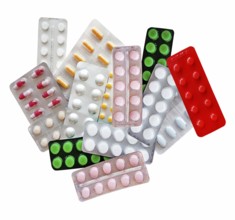 Medicines in the form of multi-colored tablets in blisters on a white background