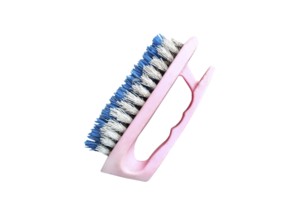 Old plastic shoe cleaning brush on white background