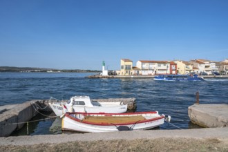 Two moored fishing boats in the foreground with a view across the Canal de Sete, formerly Canal