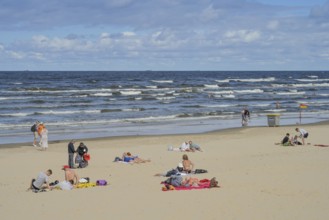 People on sandy beach, Baltic Sea, waves, Jurmala, Latvia