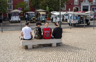 Street art, young people with Ronaldo mask on the back of their heads taking part in a school