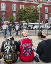 Street art, young people with Ronaldo mask on the back of their heads taking part in a school