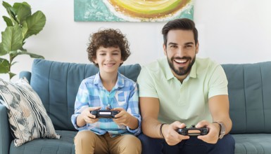 A man and a boy are playing a video game together on a couch. The boy is smiling and the man is