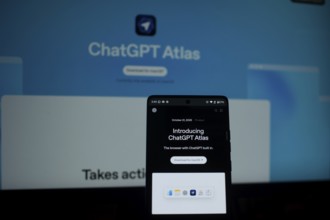 A smartphone showing ChatGPT Atlas with a bright blue background