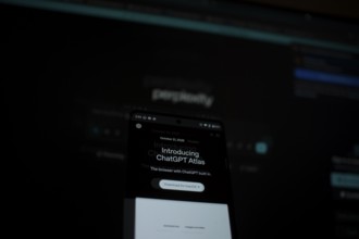 Dimly lit smartphone screen showing ChatGPT Atlas details