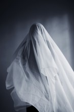 Woman with a white cloth width, ghost costume