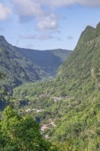 View from Department 52 of the massive, steep Remparts rock faces of Cirque du Salazie and a hamlet