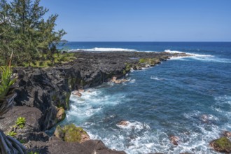 The black lava coast near the Marine de Vincendo offers a wide view of the deep blue Indian Ocean,