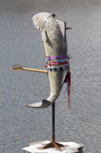 Fish sculpture with guitar, art installation What If They Bark by conceptual artist Cosima von