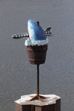 Fish sculpture with rocket in mouth, art installation What If They Bark by conceptual artist Cosima