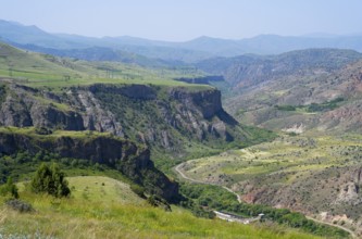 Extensive view of green valleys and rocky cliffs in mountainous surroundings, breathtaking