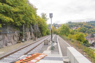 Railway tracks lead towards the city, surrounded by autumn trees, Signalbau an der Hermann