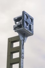 Camera on a pole, taken against grey cloudy sky, signalling at the Hermann Hessebahn, Calw, Germany