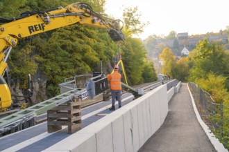 Track work with excavator, construction worker fixing objects, autumn urban landscape, signal
