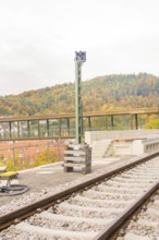 Railway tracks in autumn with a high pole next to them, Signalbau an der Hermann Hessebahn, Calw,