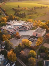 Maria von Linden Gymnasium school building in rural autumn surrounded by colorful trees, taken from