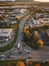 Traffic on roads through an industrial area surrounded by autumn trees, Calw, Black Forest, Germany
