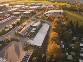 Aerial view of a commercial area in autumn with colorful trees, Calw, Black Forest, Germany