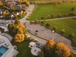 Autumn aerial view of a parking lot with colorful trees and adjacent green spaces, Calw, Black
