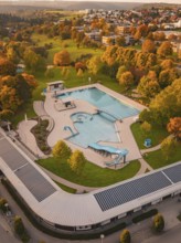 Outdoor pool with empty pool surrounded by autumn landscape and trees, Calw, Black Forest, Germany