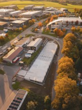Aerial view of a commercial area in autumn with colorful trees, Calw, Black Forest, Germany