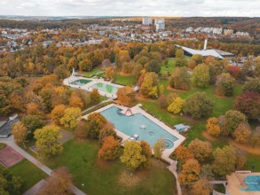 A swimming pool surrounded by autumn trees, nestled in a large park, Sindelfingen, Böblingen