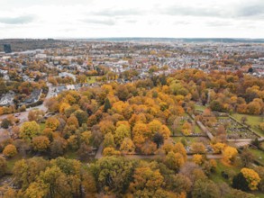Extensive view of city and autumn park with intensely coloured vegetation, Sindelfingen, Böblingen