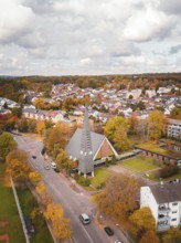 Aerial view of a village with a distinctive church and colorful autumn trees, Sindelfingen,