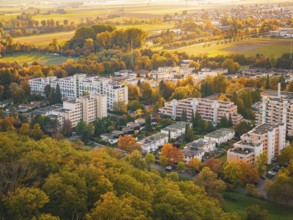 Housing development in an autumn landscape with colorful trees and vast fields, Sindelfingen,