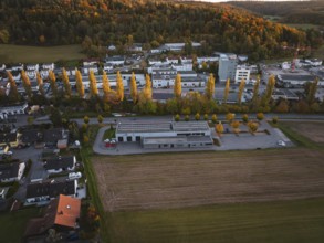 Fire station and trees in autumn landscape at dusk, Aidlingen, Böblingen district, Germany