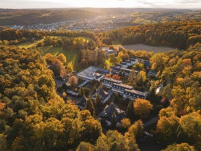 Motherhouse buildings and autumn trees in rural area at sunset, Aidlingen, Böblingen district,