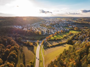 Wide landscape with a village surrounded by glowing autumn trees and fields, Aidlingen, Böblingen