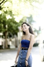 Carefree smile feeling a bit stiff with her arms, the laughing loosens up her body tension