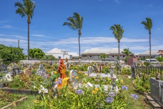 The flowery, multi-religious cemetery of Saint-Gilles-les-Hauts, with colorful graves and a Hindu